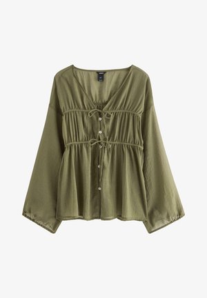 Olivengrøn bluse med V-hals, indsnævret talje, knaplukning og lange ærmer. Fremstillet af let, tekstureret stof.