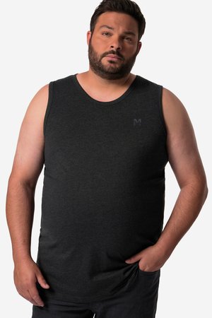 Man with beard wearing a fitted dark gray sleeveless tank top, standing with one hand in pocket against a plain white background.