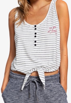 Camiseta sin mangas blanca con rayas horizontales negras, con cuello redondo, detalle de botones y dobladillo anudado. Bordado de texto en rojo que dice "nos vemos en".