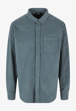 Chemise en velours côtelé bleu-gris à manches longues avec col boutonné et poche poitrine devant, fermeture à boutons sur le devant.
