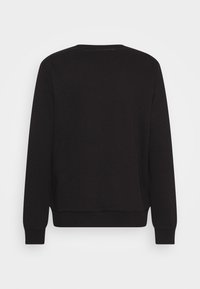 Felpa nera con maniche lunghe, scollatura rotonda e polsini a coste. Realizzata in tessuto morbido, presenta un design minimalista senza grafiche.