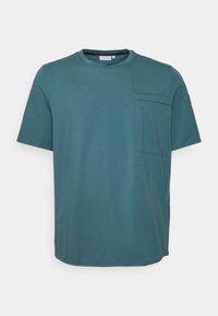 Teal short-sleeve t-shirt made of soft cotton, featuring a rounded neckline and a left chest pocket with a subtle seam detail.