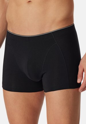 Sorte boxer briefs lavet af blødt, elastisk materiale. Har en kontureret front og en kontrastfarvet linning med diskrete tynde striber.