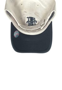 Baseball cap with a white top, black brim, adjustable strap, embroidered dark blue "NY" logo inside, and a baseball sticker on the brim.