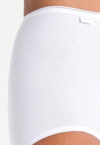 White cotton high-waisted brief with a smooth texture, featuring a decorative lace trim at the waistband and a small label tag.