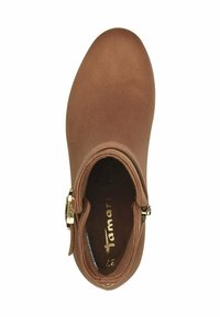 Brown ankle boot made of smooth material with a rounded toe, decorative gold hardware, and a soft interior lining.