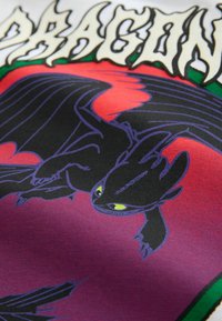 Black fabric t-shirt featuring a graphic of a dragon with yellow eyes and purple accents against a red and purple background.