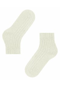 Calze a coste verde chiaro con una morbida texture, caratterizzate da un design di lunghezza media e polsini elasticizzati per una vestibilità sicura.