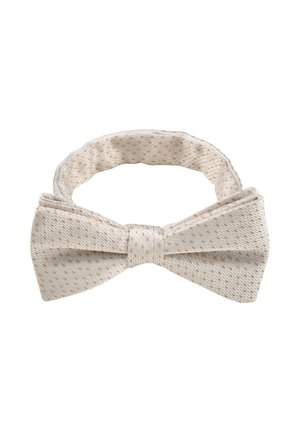 Nœud papillon en tissu couleur crème avec de subtils pois marron clair et sangle réglable sur fond blanc.