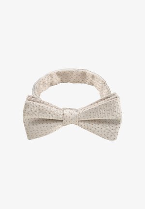 Nœud papillon en tissu couleur crème avec de subtils pois marron clair et sangle réglable sur fond blanc.