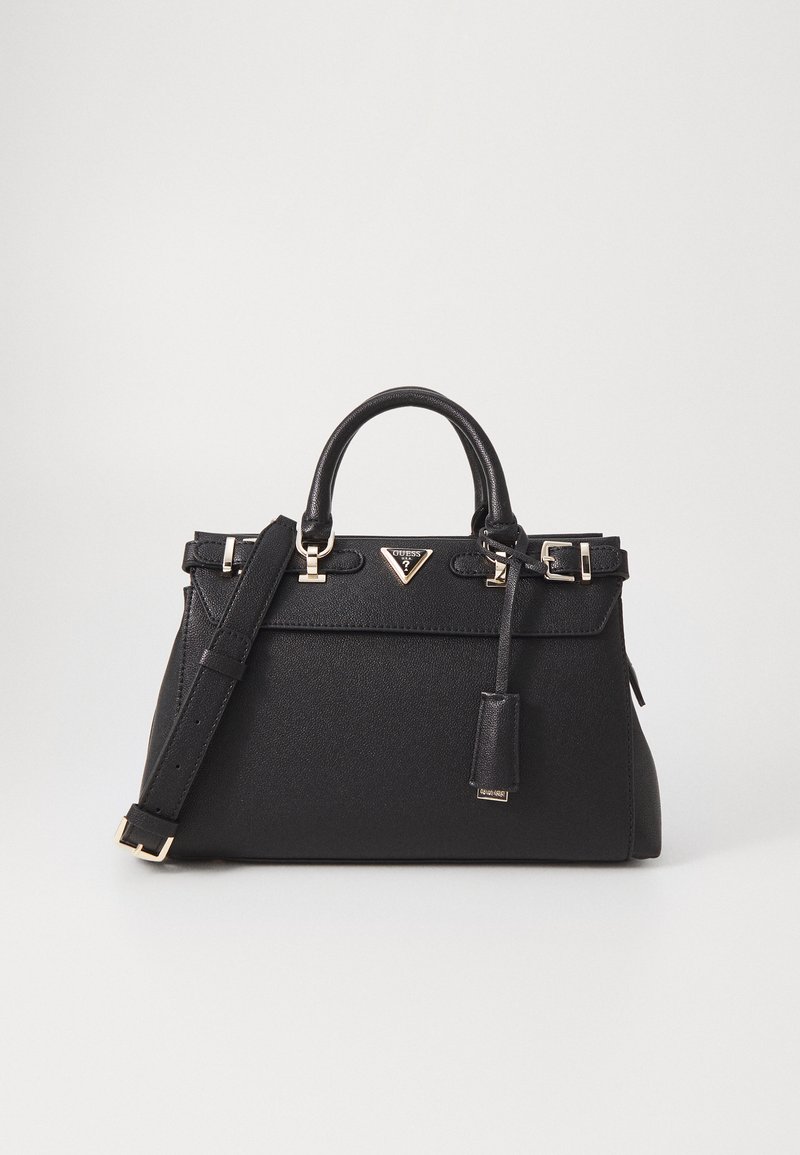 Black leather handbag with a structured shape, gold hardware, top handles, and an adjustable shoulder strap. Features a logo detail and tag.