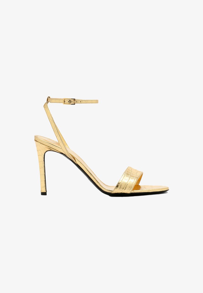 Gold, faux-crocodile leather high-heeled sandals with an ankle strap, open toe, slim stiletto heel, and a smooth, glossy finish.