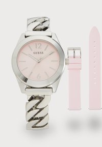 Silver-tone wristwatch with a pink dial, featuring a chain link bracelet and a removable pink silicone strap. Arabic numerals at 12 and 6.