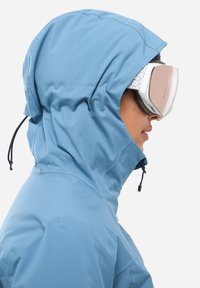 Light blue hooded jacket with adjustable drawstring, smooth texture, and a snug fit. Featured ski goggles with a mirrored lens.