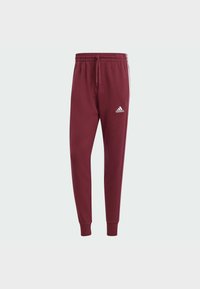 Bordo sporta bikses ar auklu jostu, ribotām acīm un baltu adidas logo. Izgatavotas no mīksta auduma, ar konusveida piegriezumu.