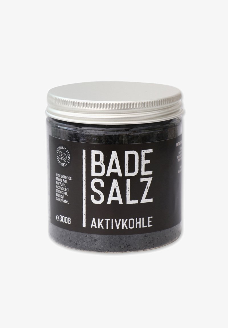 Black glass jar with a silver metal lid, labeled "Badesalz Aktivkohle," containing 300g of bath salt with visible black grains.