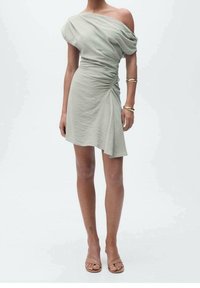 Helles grünes, schulterfreies Kleid mit Raffung an der Seite und asymmetrischem Saum. Weicher Stoff und lockerer Schnitt. Minimalistisches Design.