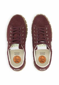 Sneakers in suede bordeaux con suole in gomma testurizzata marrone, sei occhielli e una soletta con motivo che presenta il logo del marchio.