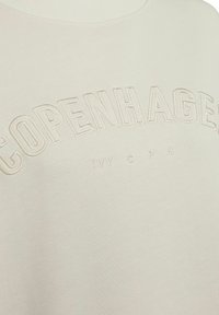 Heledbeez sweatshirt, mille tekstuuri ja sooniku kaelusega, reljeefse "KOPENHAGEN" logo ja siledaga, ideaalne vabaaja riietuseks.