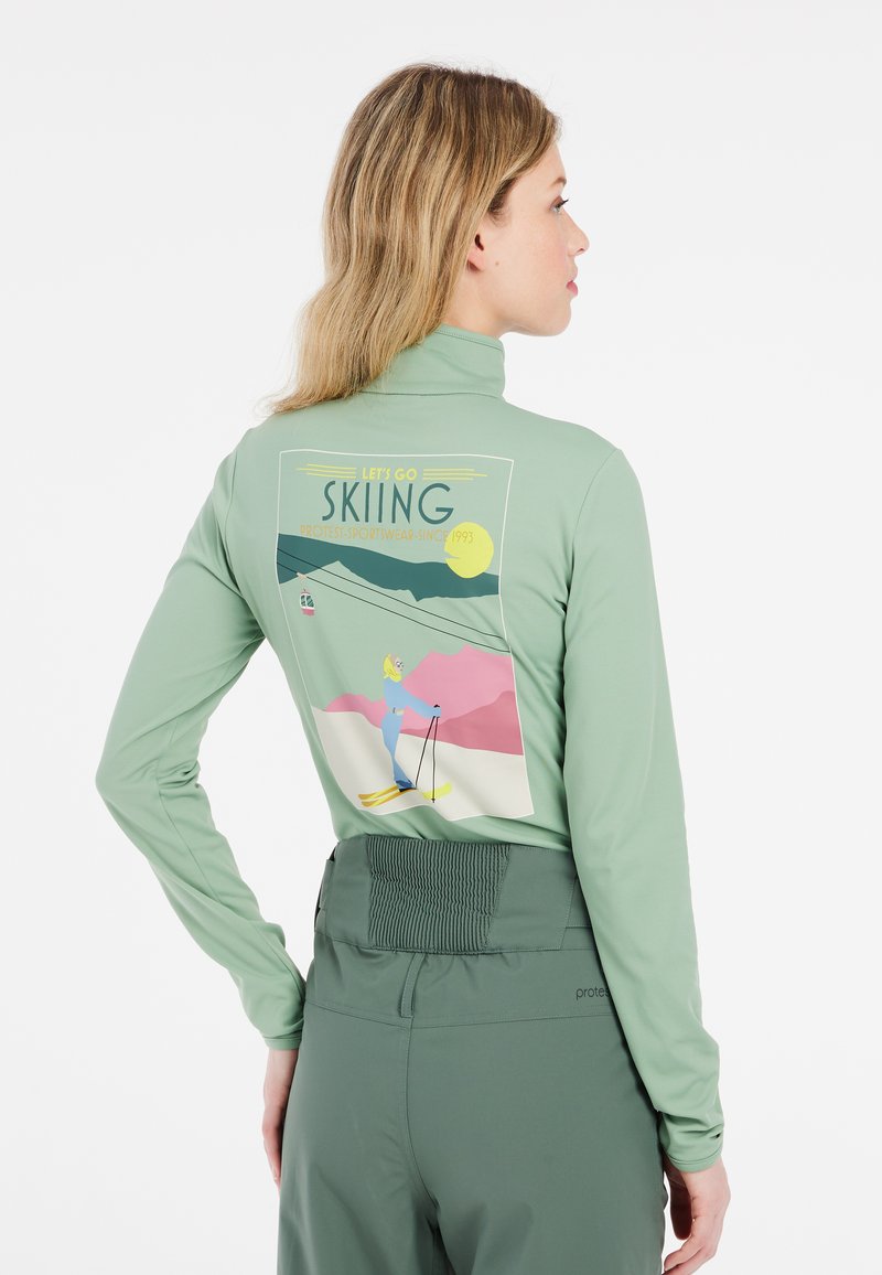 Zielona bluzka z długim rękawem, z grafiką narciarską na plecach, o wysokim kołnierzu i teksturowanej tkaninie, w komplecie z dopasowanymi zielonymi spodniami.