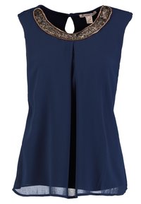 Haut sans manches bleu marine avec un col arrondi, un col orné, un détail en forme de trou de serrure au dos et une coupe légèrement ample, fabriqué en tissu léger.