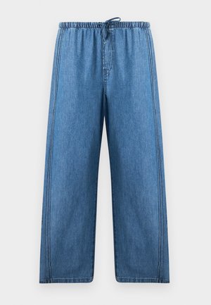 Pantalon en jean bleu à jambes larges avec taille élastique et cordon, avec des détails de coutures verticales sur les côtés et à l'avant.