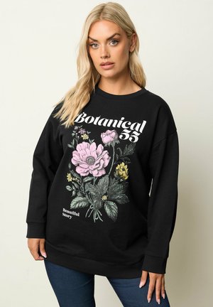 Schwarzes Sweatshirt mit langen Ärmeln, das mit einem bunten Blumenmuster in Pink, Gelb und Grün versehen ist, und dem Text "Botanical 55" auf der Vorderseite.