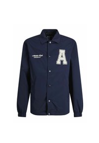 Mornarsko modra lahka jakna z zapenjanjem na gumb, ki vsebuje vezeno črko "A" in besedilo "Athletic Dept. ORIGINALS" na sprednji strani.