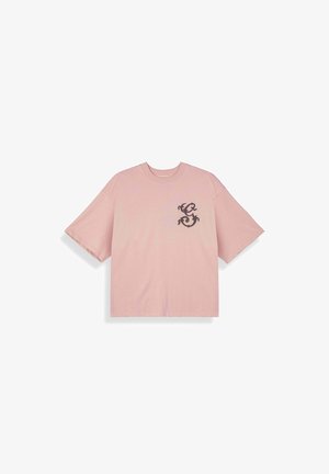 Camiseta rosa de manga corta con cuello redondo y un gráfico negro estilizado de un dragón en el pecho izquierdo.