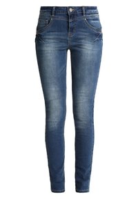 Jean skinny en denim bleu foncé, avec poches avant, style ajusté et léger délavage pour ajouter de la texture. Fermeture par bouton et zip standard.
