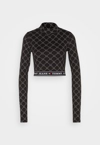 Svart långärmad crop top med geometriskt vitt mönster och silverdetaljer. Har en bred märkesdesign med "TOMMY JEANS"-text.
