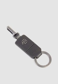 Black leather keychain with a metallic keyring, featuring a sleek design, stitching details, and a metallic accent at the top.