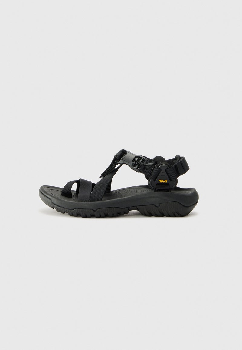 Black sandals with nylon straps and a molded rubber sole. Features adjustable buckle closure and textured footbed for grip.