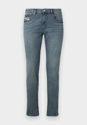 Denim jeans in medium wash with a straight leg design, five-pocket style, and subtle stitching details on the pockets and waistband.
