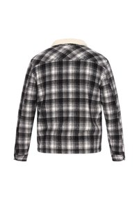 Zwart-wit geruite flanellen shirt met een zachte, gestructureerde afwerking. Voorzien van een crèmekleurige kraag en lange mouwen met knoopmanchetten.