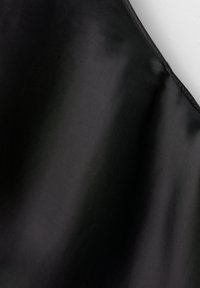 Black fabric with a smooth, slightly glossy texture, showcasing a uniform color and subtle sheen, cut in a curved shape.