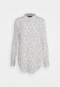 Camicia a maniche lunghe in tessuto bianco con una delicata stampa floreale nera. Presenta un colletto e un orlo curvo per una vestibilità comoda.