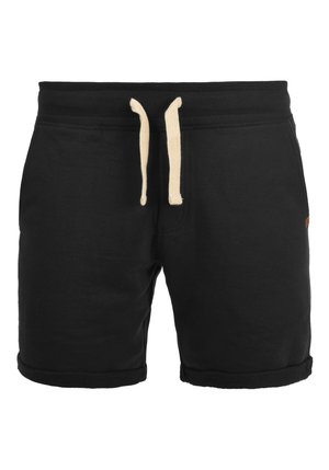 Pantalones cortos de algodón negro con una cinturilla acanalada, cordones crema y puños enrollados. Presenta un pequeño parche con el logo en el lateral.
