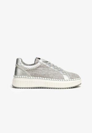 Silver sneakers featuring a textured grey upper, a sleek design, flat white sole with ribbed detailing, and subtle stitching accents.