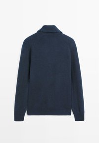 Navy blue ribbed sweater with a high collar, long sleeves, and side slits. Knitted texture, showcasing horizontal and vertical lines.