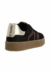 Black sneaker with a textured finish, brown stripes, and metallic silver heel accent. Features a thick gum sole for traction.