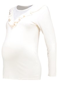 Maglietta premaman a maniche lunghe, in tessuto bianco, presenta dettagli arricciati sul colletto, una consistenza morbida e un design aderente per adattarsi a una pancia in crescita.