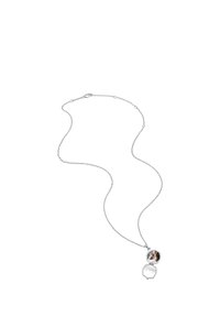 Delicate silver locket necklace with an open round pendant showing a photo of two people embracing inside.