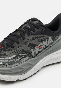 HOKA STINSON 7 - Zapatillas de trail running - black/outer orbit