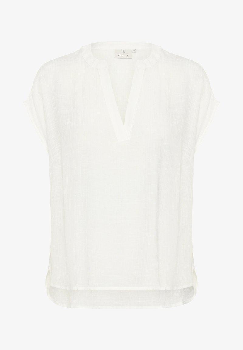 Blouse blanche à manches courtes en tissu léger, avec un décolleté en V et une coupe décontractée dotée d'un ourlet légèrement arrondi.