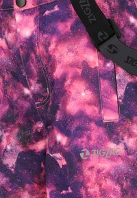 Purple and pink galaxy-patterned pants with a smooth texture, featuring a black belt with a branded buckle and a front pocket.