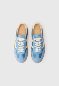 Sneaker blu e verde acqua con accenti beige, caratterizzati da una tomaia in suede e pelle, punta rotonda, lacci piatti e suola in gomma.