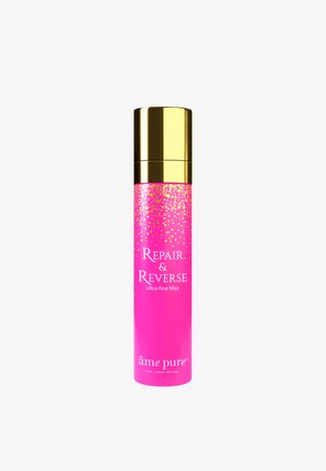 Pink cylindrical bottle with golden accents, labeled "Repair & Reverse Ultra-fine Mist," featuring a dotted design towards the top.
