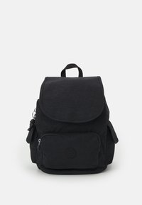Black fabric backpack with a flap closure, front zip pocket, side pockets, and a top handle. Features a subtly textured surface and logo.