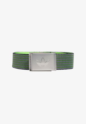 Woven elastic belt in black, green, and white with a silver metal buckle featuring an embossed logo. Textured surface, adjustable length.